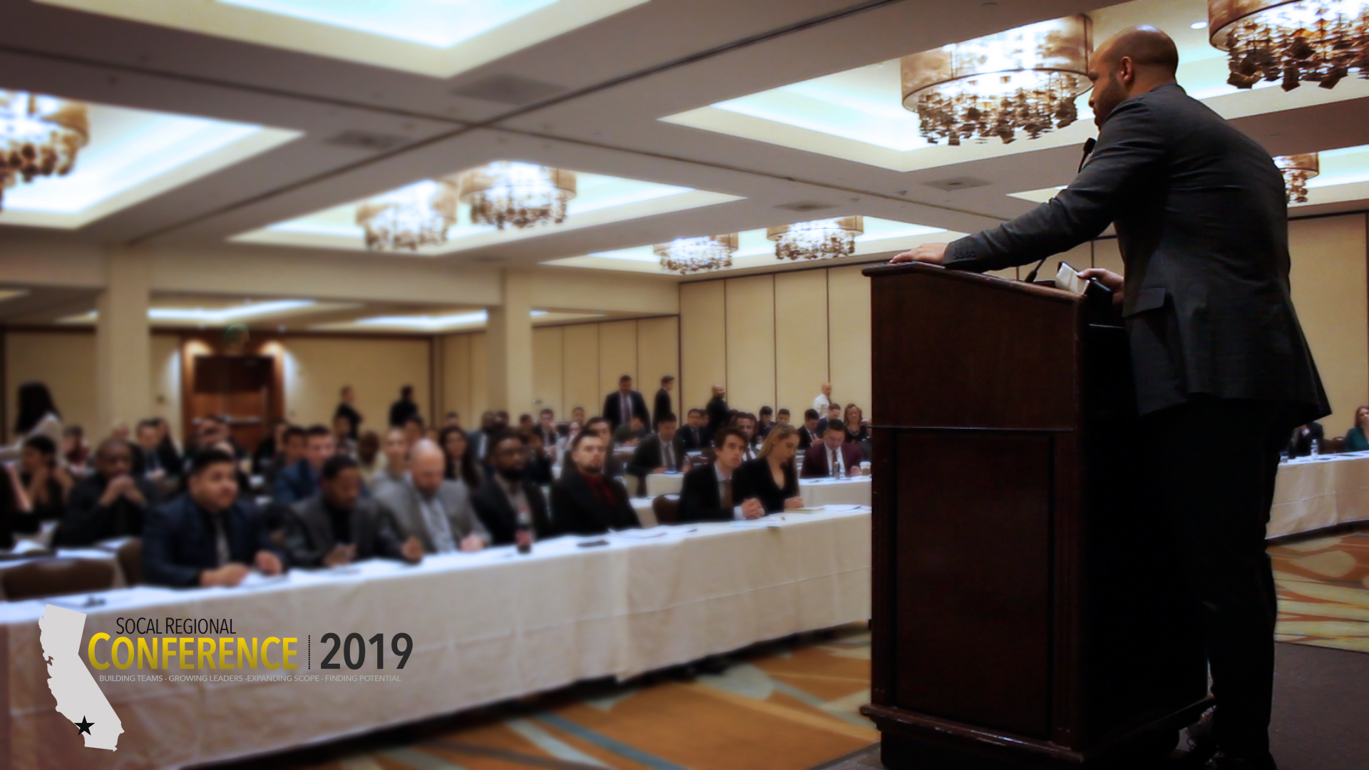 True Vision team gathered at the SoCal Regional Conference 2019, with team members in professional attire celebrating achievements